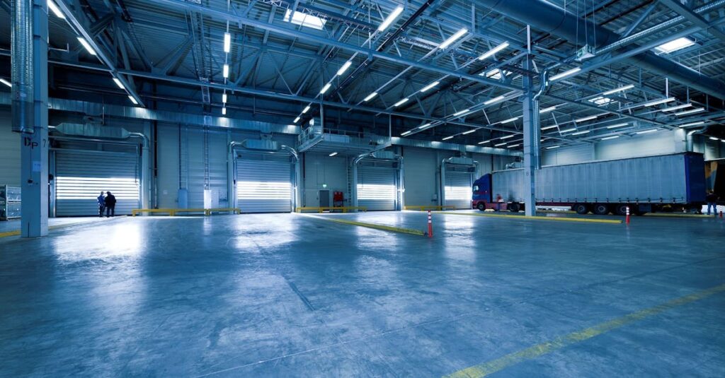 Large warehouse interior with docked truck, ideal for logistics and warehousing.