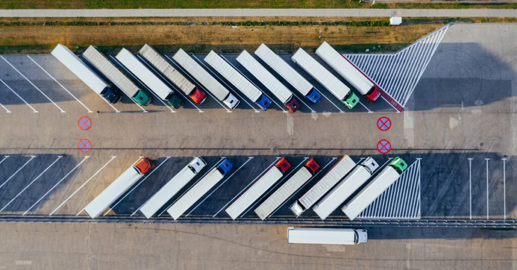 Overhead shot of semi-trucks parked in Poznań, Poland, demonstrating transportation logistics.